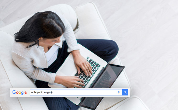 Image displaying young woman on couch searching google